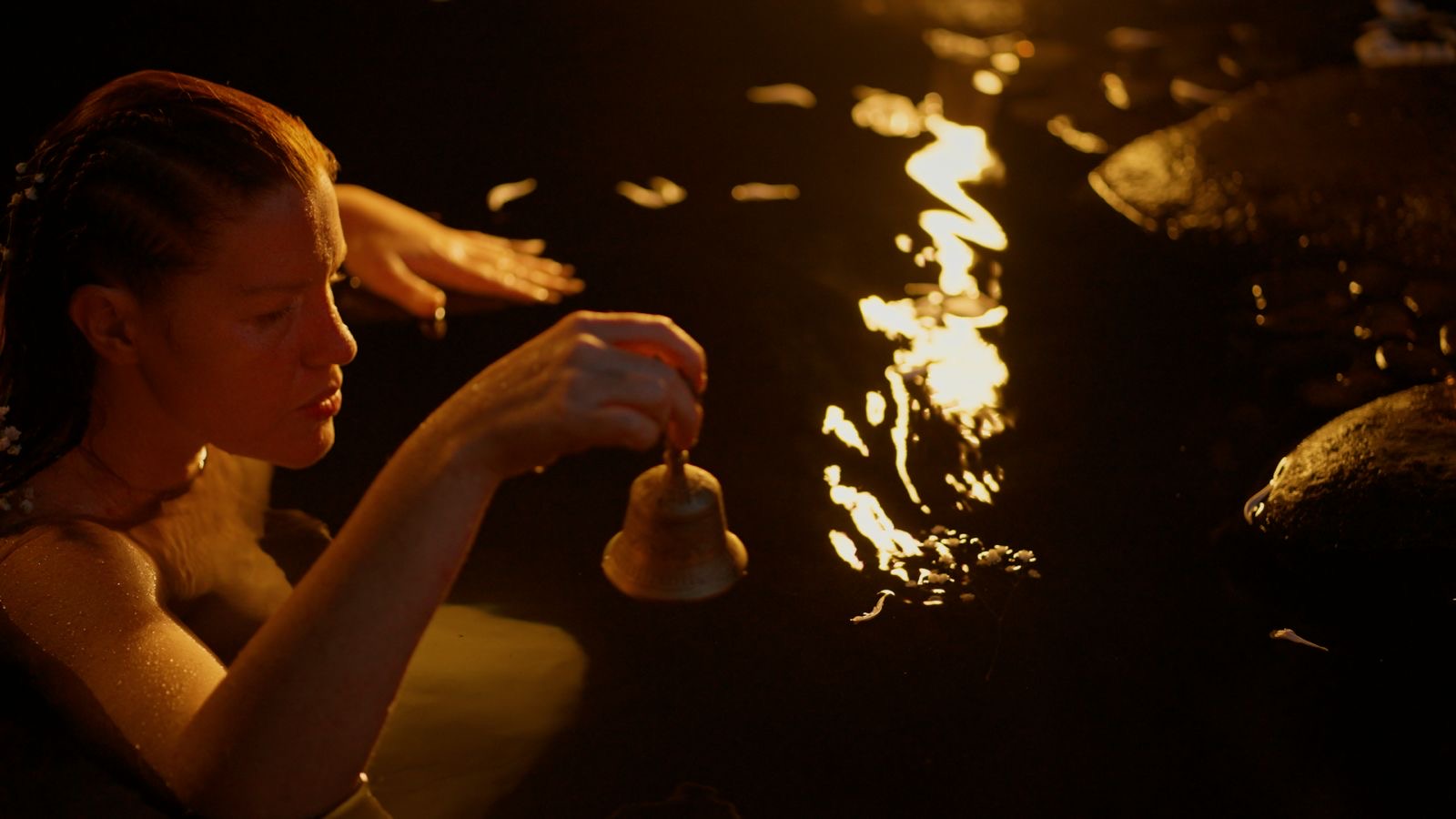 Ceremonial bathing with a bell at golden hour